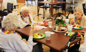 Sister Mary Durr, second from left, the most senior sister in the community at age 98, smiles as she enjoys her treat of fruit, along with Sister Rosalin Thieneman, right, and Sister Judith Osthoff, left.