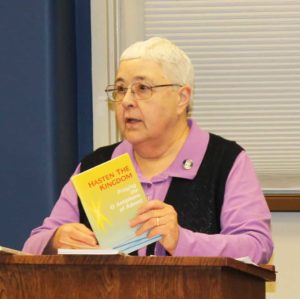 Sister Ann McGrew holds one of the books she used to prepare her talk on the “O Antiphons.”