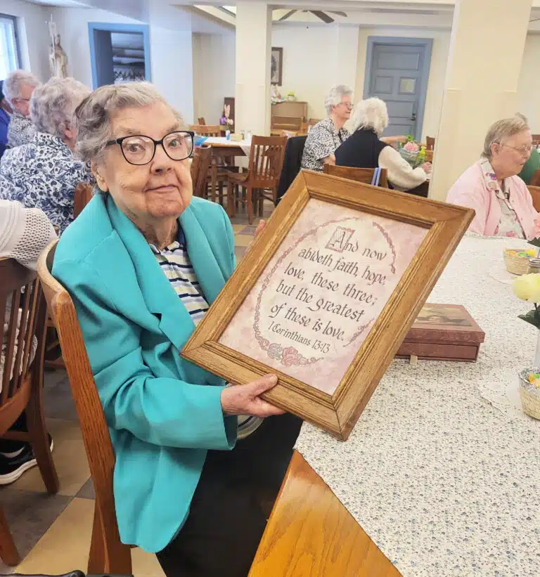 Ursuline Sister Paul Marie Greenwell holds a framed bible verse she won during the Spring Fling. Ursuline Sister Paul Marie Greenwell holds a framed bible verse she won during the Spring Fling.