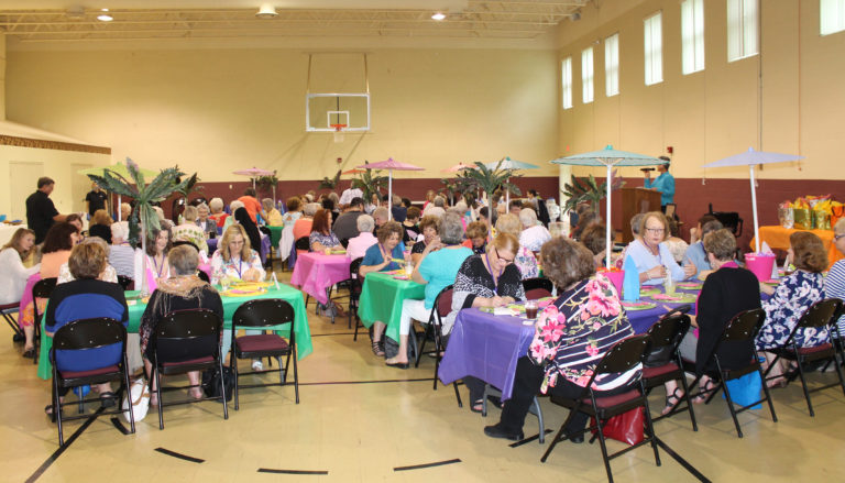 More than 100 alumnae and a few guests gathered in the gym, which was decorated with a Hawaiian theme this year.