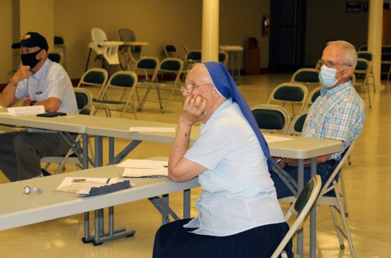 Sister Mary Thomas Simon, a Sister of the Lamb of God, and Lane Rhodes, seated to her right, listen as the speaker reminds them that God loves each of us no matter our age.