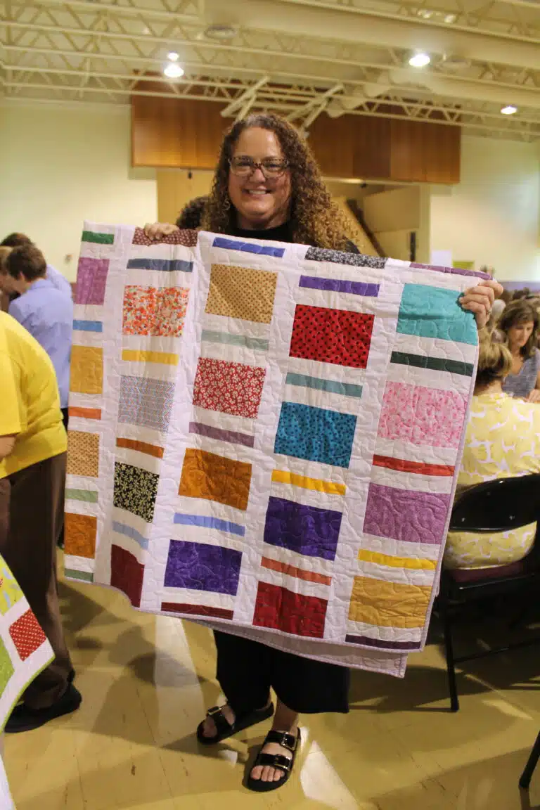Amanda Denton of Newburgh, Ind., liked his colorful “Sticks and Bricks” quilt. Amanda Denton of Newburgh, Ind., liked his colorful “Sticks and Bricks” quilt.