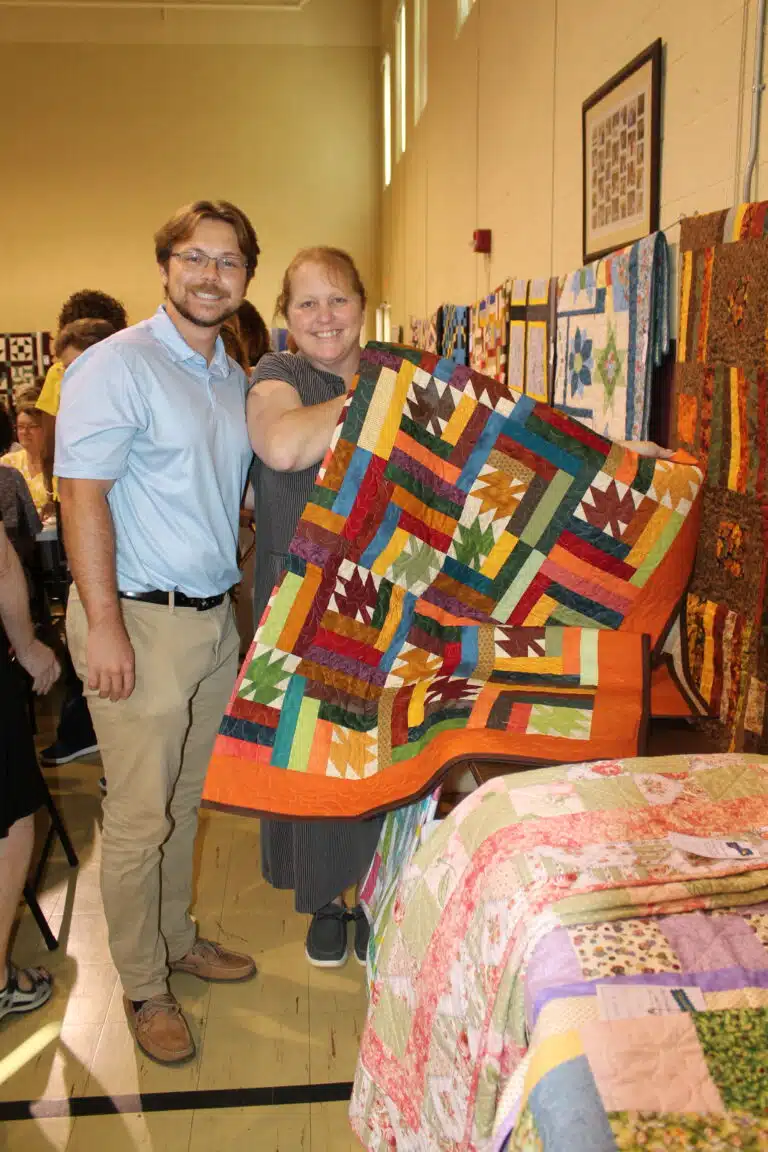 Amy Troutman of Owensboro was the lucky winner of the “Scattered Leaves” Fall quilt. She posed for a picture with her son Cole Troutman, who works in the Finance office at Mount Saint Joseph. Amy Troutman of Owensboro was the lucky winner of the “Scattered Leaves” Fall quilt. She posed for a picture with her son Cole Troutman, who works in the Finance office at Mount Saint Joseph.