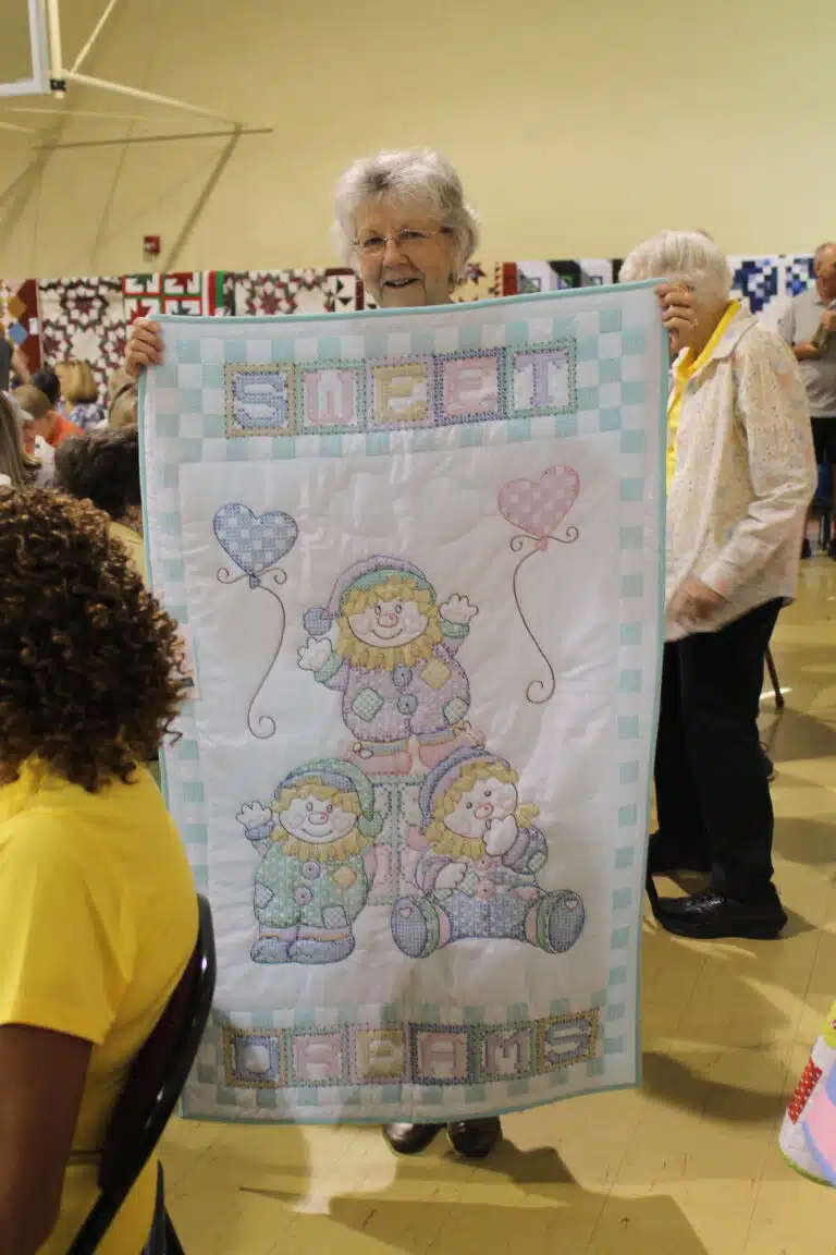 Stanette Blair of Owensboro was smiling when she held up her new “Clowning Around” baby quilt. Stanette Blair of Owensboro was smiling when she held up her new “Clowning Around” baby quilt.
