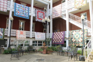 Quilts made by the Runaway Quilters decorate the balconies of the Mount Saint Joseph Conference and Retreat Center courtyard.