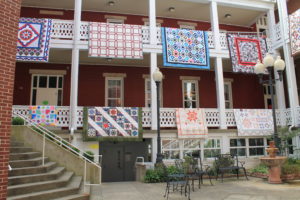 Quilts made by the Runaway Quilters decorate the balconies of the Mount Saint Joseph Conference and Retreat Center courtyard.