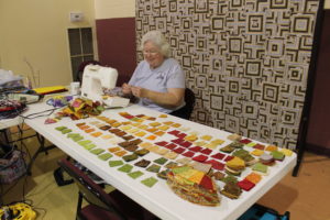 Brenda Coffey of Bowling Green, Ky., puts together lots of fabric pieces to make a double wedding ring quilt.