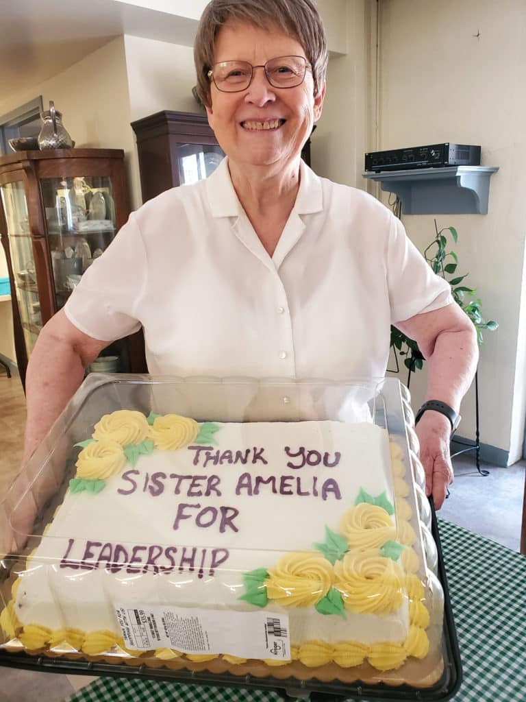 Sister Amelia Stenger, congregational leader, poses with her cake. Sister Amelia has been an Ursuline for 54 years.