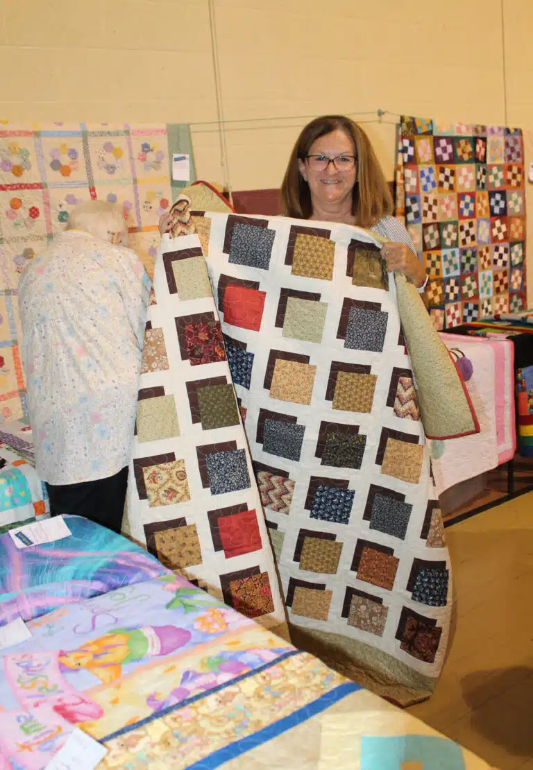 Ginger McBride of Philpot picked out the colorful “Shadow Blocks” quilt. Ginger McBride of Philpot picked out the colorful “Shadow Blocks” quilt.