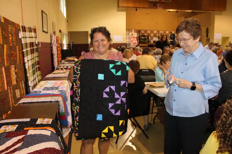 Angela Hypes of Salem, Ind., took home the “Double Duty” quilt as the second winner in game 26. Sister Mary Henning, right, smiled after helping Angela with her new quilt. Angela Hypes of Salem, Ind., took home the “Double Duty” quilt as the second winner in game 26. Sister Mary Henning, right, smiled after helping Angela with her new quilt.