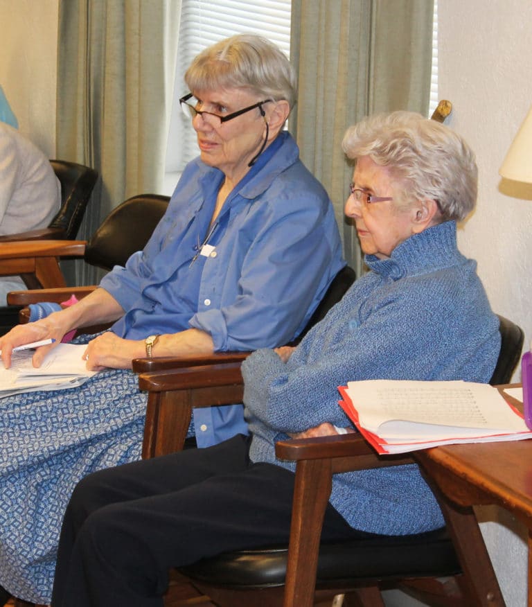 Sister Sheila Anne Smith, left, and Sister Naomi Aull listen to Sister Cheryl discuss Saint Catherine of Siena.