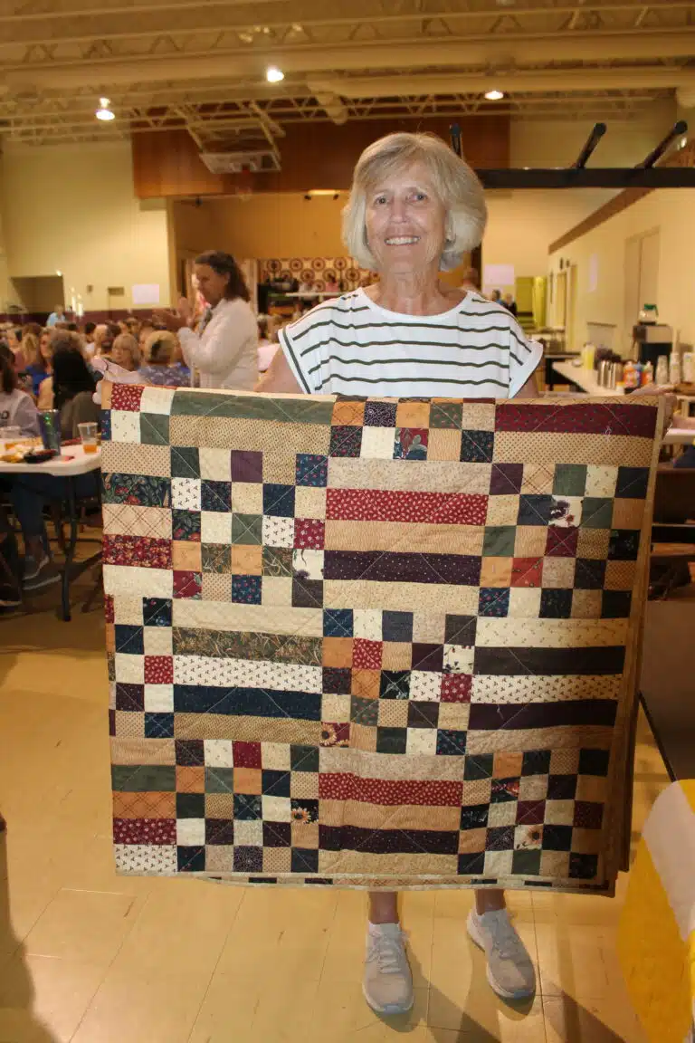 Karen Cummins of Fredericksburg, Ind., was happy to have this “Primitive Picnic” quilt after winning the 30th game. Karen Cummins of Fredericksburg, Ind., was happy to have this “Primitive Picnic” quilt after winning the 30th game.