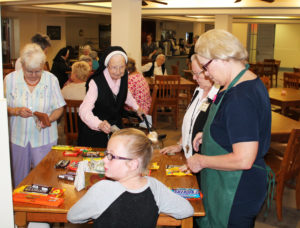 The line for candy immediately formed and didn’t stop for quite a while. From left are Sister Cecelia Joseph Olinger, Sister Emerentia Wiesner, Sister Catherine Marie Lauterwasser and food service employee Mary Lykins.