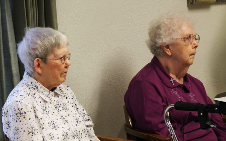 Sister Marie Montgomery, left, and Sister Mary Agnes VonderHaar follow along with Sister Cheryl’s lesson. Sister Marie is the oldest in the community but knows making retreat is important.