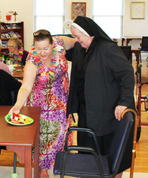 Debbie Dugger clearly makes Sister Marian Powers happy as she provides her with a fruit plate.