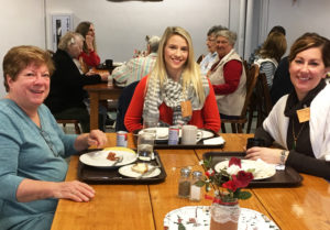 Ursuline Associate Joan Perry, left, is joined by Jessica Dilsaver, center, and Jenny Likens over breakfast Saturday.