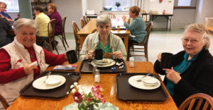 Ursuline Associate Elaine Wood, left, enjoys her coffee with Ursuline Sisters Sheila Anne Smith, center, and Marie Joseph Coomes.