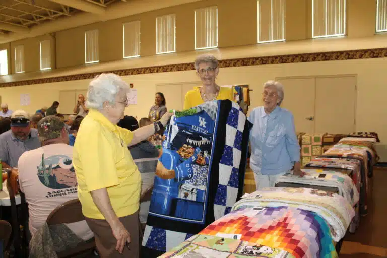 Mary Ann Burke of Louisville, center, was excited to win the “UK Love” Kentucky sports-themed quilt. Sister Cecelia Joseph Olinger, left, and Mary Ann’s sister-in-law, Sister Elaine Burke, assisted as she picked up her quilt. Mary Ann Burke of Louisville, center, was excited to win the “UK Love” Kentucky sports-themed quilt. Sister Cecelia Joseph Olinger, left, and Mary Ann’s sister-in-law, Sister Elaine Burke, assisted as she picked up her quilt.