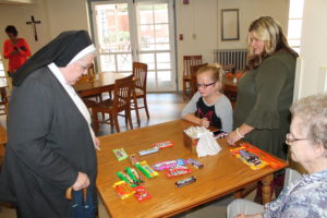 Sister Marian Powers, left, looks over the remaining selection to make her choice.