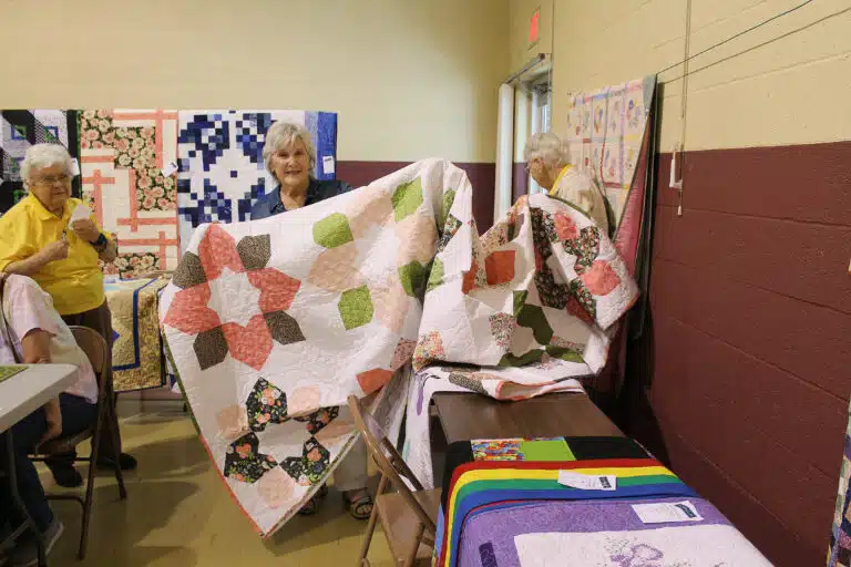 Sue Fowler of Evansville, Ind., selected a quilt called “Wild Kingdom.” Sister Cecelia Joseph Olinger stands at left. Sue Fowler of Evansville, Ind., selected a quilt called “Wild Kingdom.” Sister Cecelia Joseph Olinger stands at left.