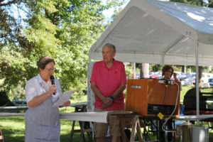 Congregational Leader Sister Amelia Stenger opens the picnic with a prayer, which included blessings for those who died in the Sept. 11 attacks in the United States 15 years earlier. Standing at right is Ursuline Associate Jerry Birge, who was the emcee and made announcements on the speaker throughout the day.