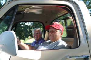 Sister Mary Jude Cecil, left, rides in a truck with Ursuline Associate Mary Danhauer, as they drop off tables, chairs and other supplies needed in the picnic booths.