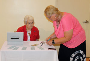 Sister Cecelia Joseph Olinger, left, sells raffle tickets to Ann Jacobs at the gala. This year’s raffle drawing will take place Sept. 10 during the new MapleFest at the Mount.