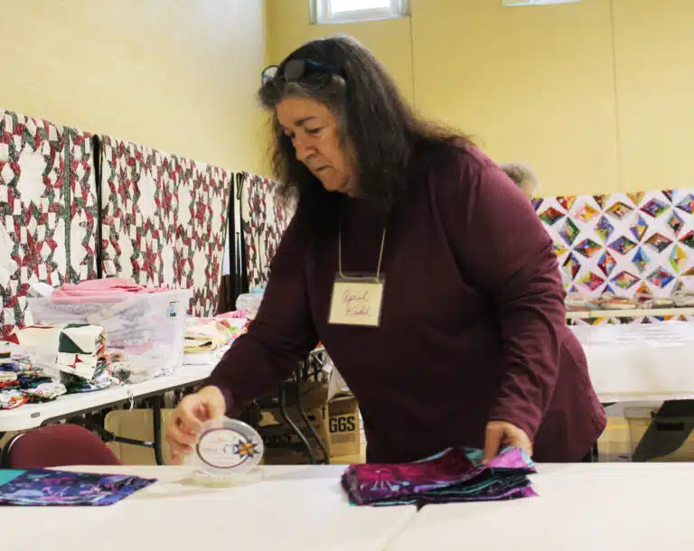 April Kidd, from Tell City, Ind., sorts her squares she is using to make a quilt top. “I hope to do one a day while I’m here,” she said. April Kidd, from Tell City, Ind., sorts her squares she is using to make a quilt top. “I hope to do one a day while I’m here,” she said.