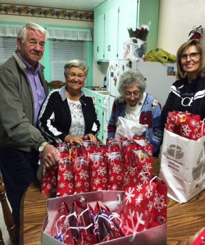Ursuline Associates Mike Sullivan, Elaine Wood, Ursuline Sister Teresa Riley and Associate Risë Karr prepare gift bags for the sisters in the Guest House prior to the party.