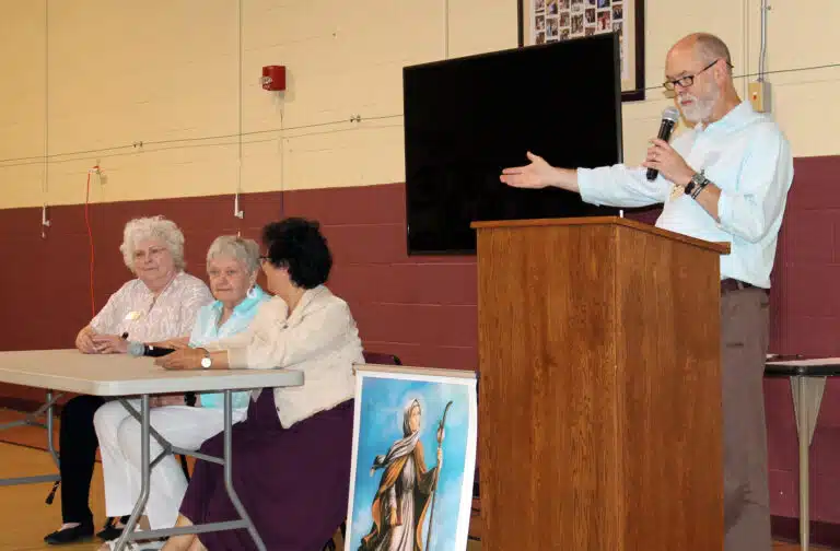 Associate Dan Heckel welcomes and points out the panel of speakers who are Associates with the Ursuline Sisters of Louisville: left to right, Patricia Hagan, Theresa Butler, and Lisa Steiner. The group talked about the new direction the Louisville Associates had taken. Associate Dan Heckel welcomes and points out the panel of speakers who are Associates with the Ursuline Sisters of Louisville: left to right, Patricia Hagan, Theresa Butler, and Lisa Steiner. The group talked about the new direction the Louisville Associates had taken.