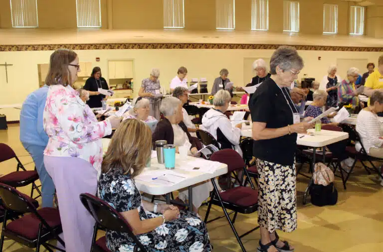 The Ursuline Sisters stand to read the Response of the Community to the Associates, including promising to pray for them daily. The Ursuline Sisters stand to read the Response of the Community to the Associates, including promising to pray for them daily.
