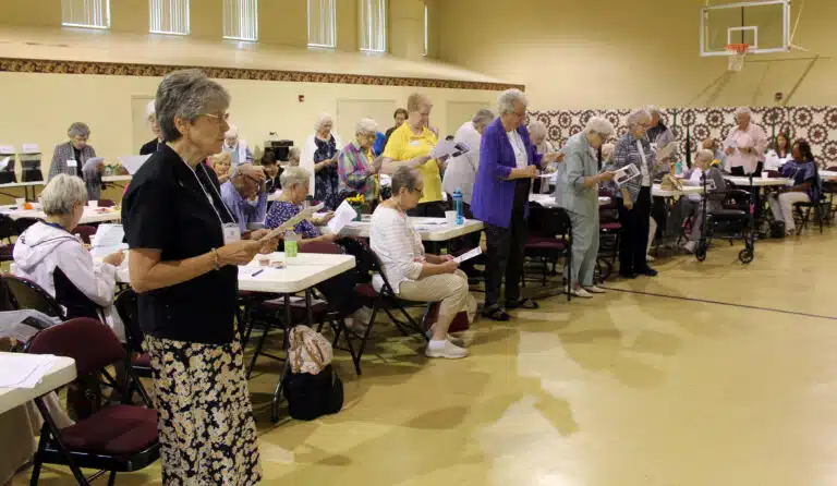 The Ursuline Sisters stand to read the Response of the Community to the Associates, including affirming them in the spirit of Saint Angela. The Ursuline Sisters stand to read the Response of the Community to the Associates, including affirming them in the spirit of Saint Angela.