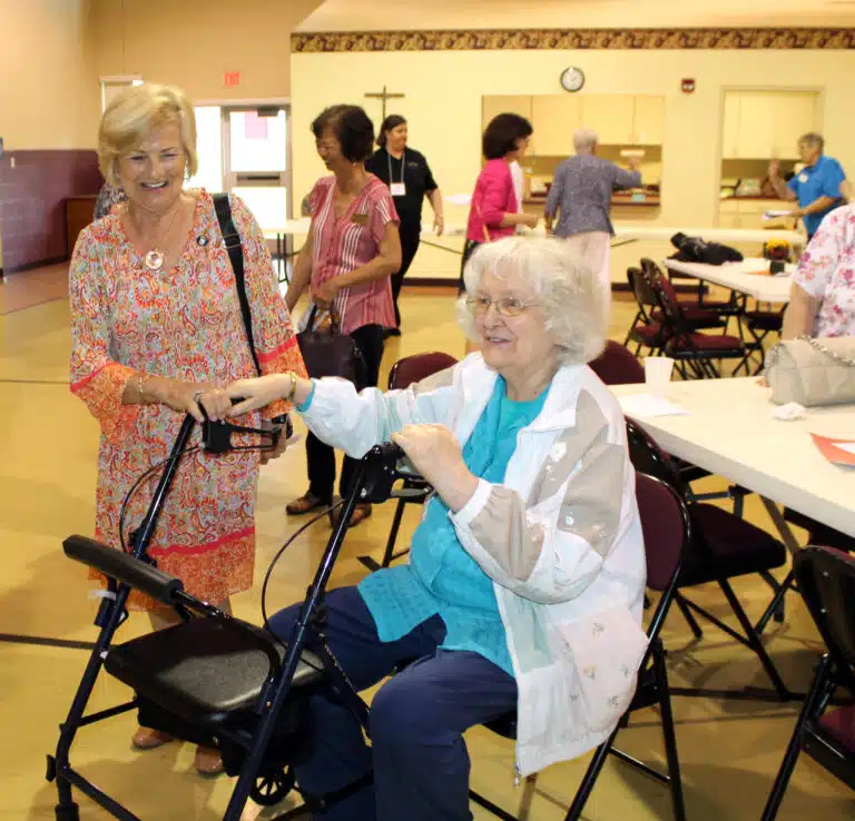 Associate Carol Hill, left, smiles as she greets Sister Francis Louise Johnson at the closing of the event. Associate Carol Hill, left, smiles as she greets Sister Francis Louise Johnson at the closing of the event.