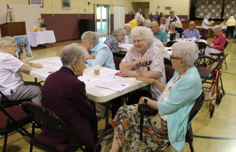 Patricia Hagan, an Associate for the Ursulines of Louisville, smiles as she speaks with Sister Joan Riedley who was seated across from her. Her fellow Associate, Regina Leitner, is seated at the end. Patricia Hagan, an Associate for the Ursulines of Louisville, smiles as she speaks with Sister Joan Riedley who was seated across from her. Her fellow Associate, Regina Leitner, is seated at the end.