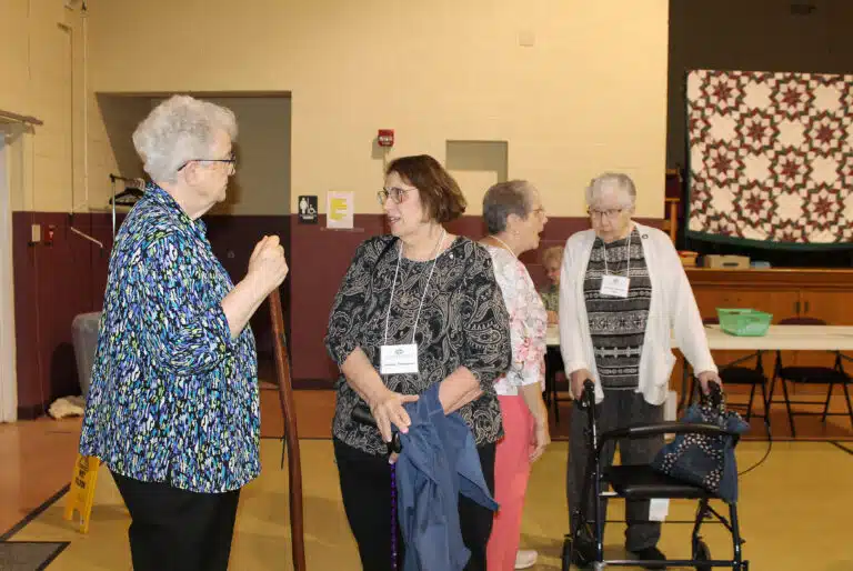 Sister Michele Morek greets Associate Joanne Thompson of Paola, Kansas, at the event. Sister Michele Morek greets Associate Joanne Thompson of Paola, Kansas, at the event.