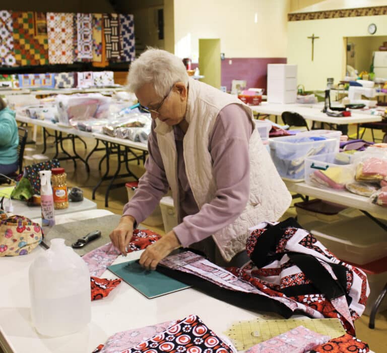 Beverly Howell, of Covington, Tenn., works on the border for a quilt top on March 11, 2024. This was her third year taking part in the Quilting Friends.