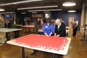 Dr. Ashley Holland, left, and Sister Julia Head are almost done with this blanket. Holland is chair of the School of Education at Brescia. Sister Sharon Sullivan and Sister Betsy Moyer are on the faculty and staff of that department. Sister Julia and Sister Betsy are also Brescia graduates.