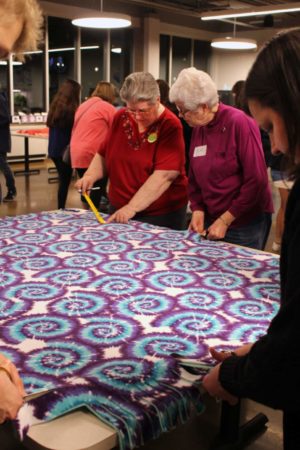 Sister Rose Jean Powers, left, and Sister Barbara Jean Head confer about the length of the fringe on a blanket.