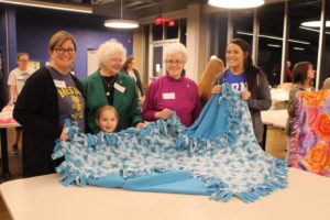 This group displaying a completed blanket includes Sister Vivian Bowles, second from left, and Sister Barbara Jean Head, third from left.