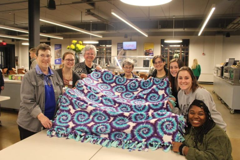 Sister Sharon Sullivan, left, Sister Mary Timothy Bland, third from left, and Sister Judith Nell Riney, center, are proud of this blanket decorated with swirls.