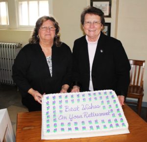 Debbie Rafferty and Sister Amelia Stenger, congregational leader, pose with the retirement cake.