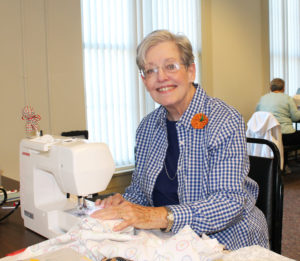 Carol Martin sews a pillow case with bicycles on it, a Christmas present for her daughter and son-in-law.