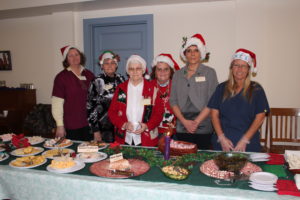 Several of the Retreat Center staff stand behind their table of goodies. Left to right: Elaine Foster, Cyndy Madi, Sister Mary Matthias Ward (Center executive director), Sheila Blandford, Trish Durham, and Faye Smith.