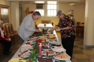 Sister Ruth Gehres, left, and Sister Pat Rhoten partake of the finger foods set up in the dining room.