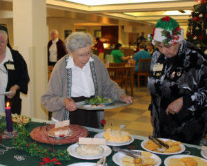 Sister Grace Swift, left, listens as Cyndy Madi tells her what some of the dishes are called.