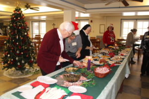 Sister Mary Jude Cecil, left, is helped by Center Food Service Manager Trish Durham.