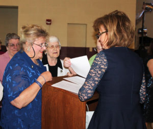 Associate Suzanne Reiss, left, smiles as she enters the dinner and speaks to Sherri Heckel. In the center of the picture is Sister Mary Matthias Ward, and far left, Sister Rose Jean Powers.