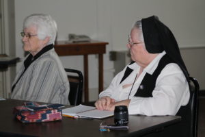 Sister Catherine Marie Lauterwasser, right, prepares to take notes. Seated at left is Sister Mary Matthias Ward.