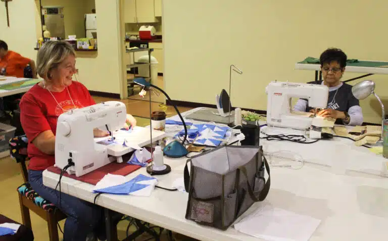 Cindy Murphy, left, laughs with Karen McCarty as they sew on Monday, March 10, 2025. It was Murphy’s first time with the Quilting Friends. “She has all this fabric for us, it’s great.” McCarty is a 1974 graduate of Mount Saint Joseph Academy. Cindy Murphy, left, laughs with Karen McCarty as they sew on Monday, March 10, 2025. It was Murphy’s first time with the Quilting Friends. “She has all this fabric for us, it’s great.” McCarty is a 1974 graduate of Mount Saint Joseph Academy.