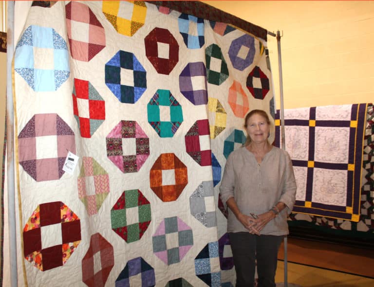 Clara Beth Steward of Morganfield, Ky., poses with her new quilt.
